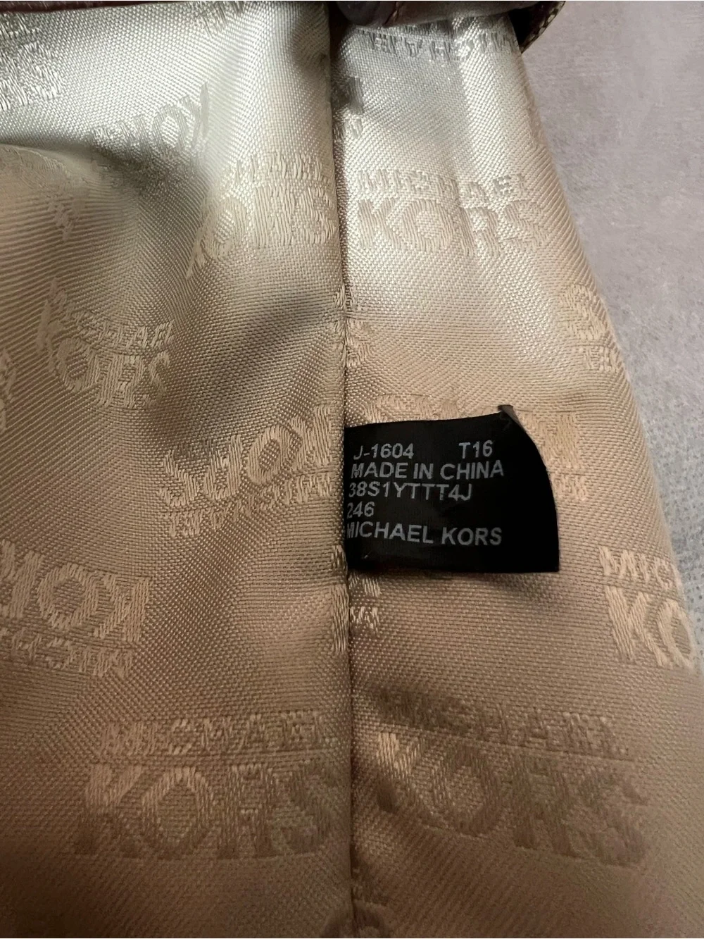 Michael Kors Jet Set tote features monogram canvas, contrasting leather straps